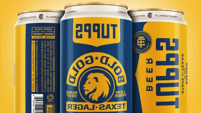 Close-up of blue and gold beer can with "Tupps" printed at the top and Lion logo below.